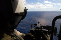 Aviation Warfare Systems Operator firing a 50 caliber machine gun poster print