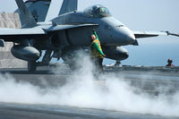 Aviation Boatswain's Mate signaling F/A-18C Hornet on USS George Washington
