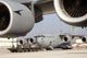 A C-17 Globemaster III awaits loading poster print showcasing a military aircraft.