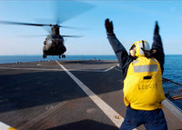 Boatswain's Mate signaling to a CH-47 Chinook helicopter poster print.