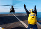 Boatswain's Mate signaling to a CH-47 Chinook helicopter poster print.