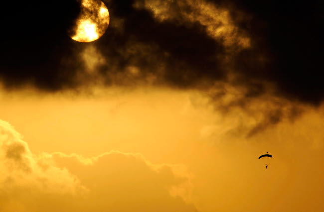 Parachute jumper descending during a training mission poster print.