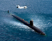 CH-46 Sea Knight hovering above an attack submarine poster print.