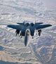 F-15E Strike Eagle soaring over Afghanistan mountains poster print