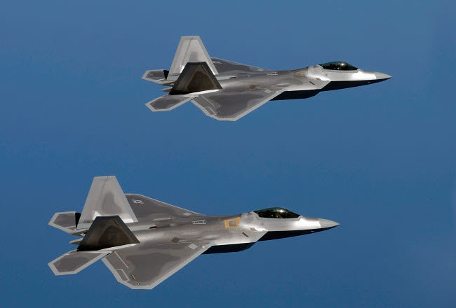 F-22A Raptors flying over Langley Air Force Base, Virginia poster print.