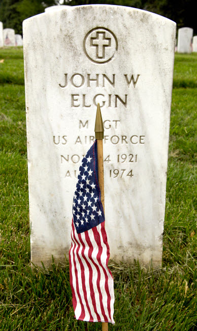American Flag in front of a headstone poster print.