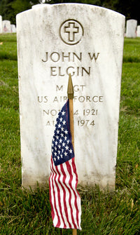 American Flag in front of a headstone poster print.