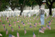 A Family Member Pays Respects at a Grave Site Poster Print