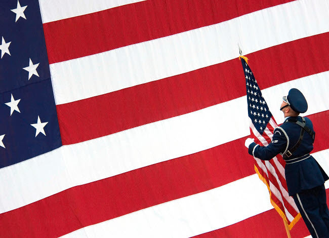 Airman posting the American flag during a change of command ceremony poster print.