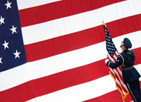 Airman posting the American flag during a change of command ceremony poster print.