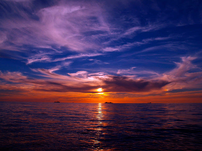 Ships patrol the waters off the coast of France poster print.