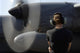 Soldier monitoring C-130 Hercules engine at Camp Lemonnier poster print