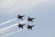 The Blue Angels performing aerial maneuvers in a stunning poster print.