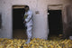 Iraqi army soldier checking corn storage room during military operation.