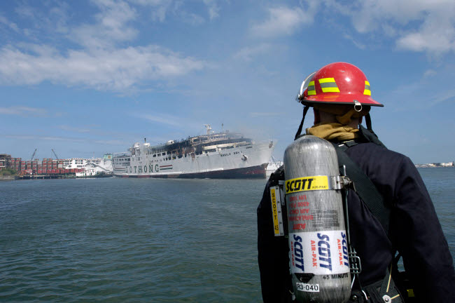 US Navy Sailor Responds to Shipboard Fire Poster Print
