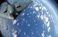 KC-135 Stratotanker refueling B-2 Spirit over the Pacific Ocean poster print.