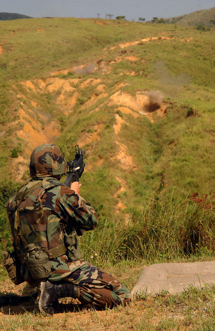 Petty Officer firing 40mm highly explosive round at Camp Hansen, Okinawa, Japan poster print.