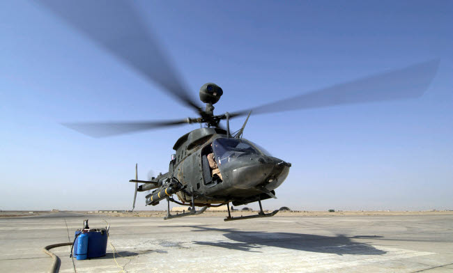 OH-58D Kiowa Warrior helicopter taking off from Forward Operating Base MacKenzie in Iraq poster print.