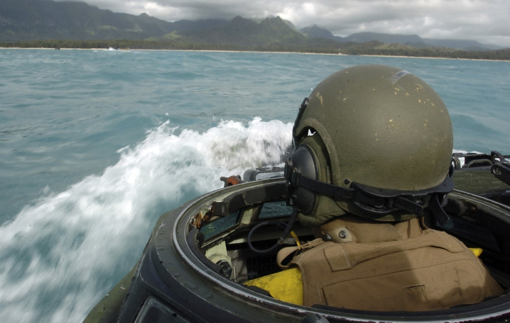 U.S. Marine driving an amphibious assault vehicle through the Pacific Ocean.
