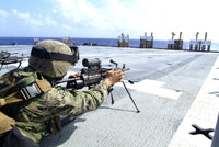 U.S. Marine adjusting weapon during live-fire exercise on USS Harpers Ferry.