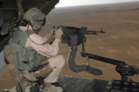 U.S. Marine test fires 240 Gulf heavy machine gun from MV-22B Osprey over Al Asad Air Base, Iraq.