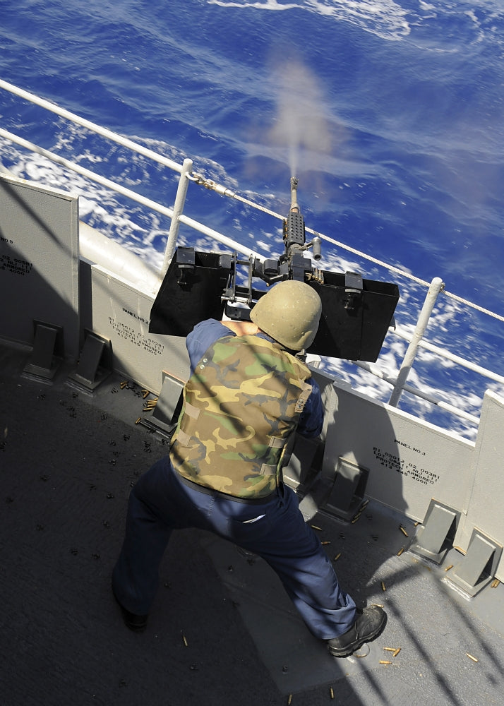 Mediterranean Sea military poster featuring a Gunners Mate firing a .50 caliber machine gun.