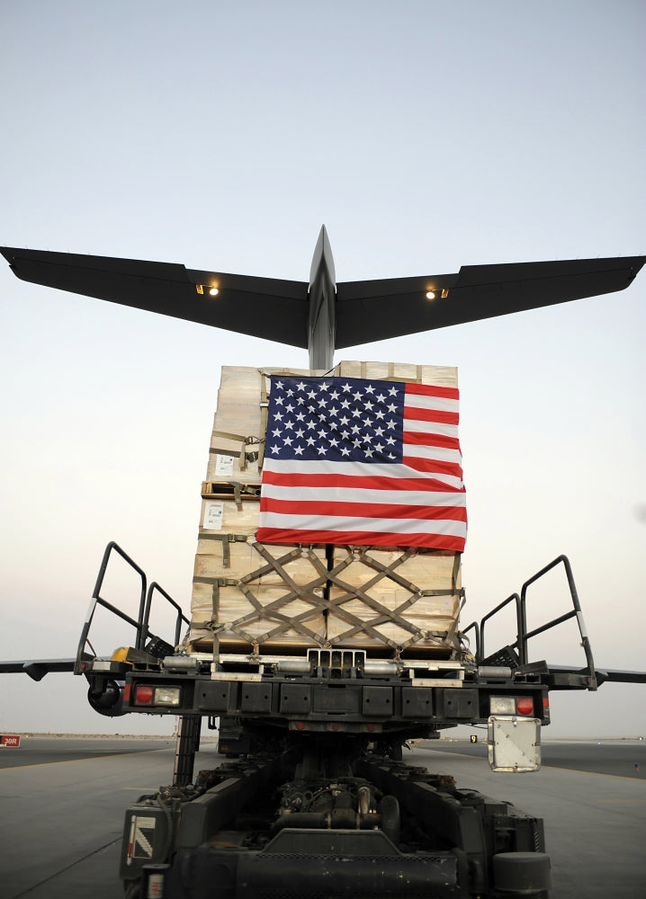 Humanitarian relief supplies being loaded into C-17 Globemaster III cargo bay.
