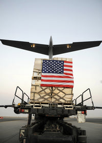 Humanitarian relief supplies being loaded into C-17 Globemaster III cargo bay.
