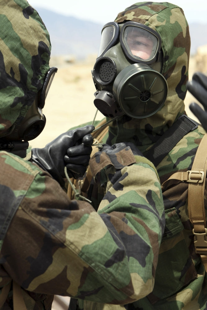 U.S. Marine Corps Reservists in Camouflage Print assisting each other.