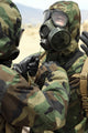 U.S. Marine Corps Reservists in Camouflage Print assisting each other.