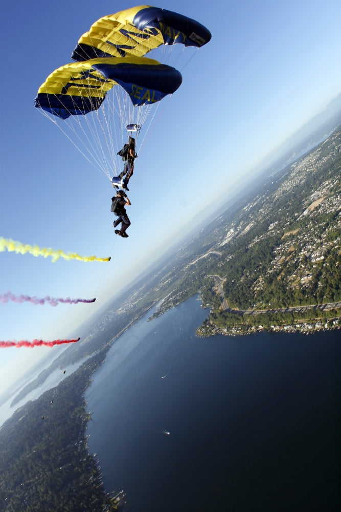 Leap Frogs U.S. Navy Parachute Team performing bi-plane maneuver above Seattle skyline.