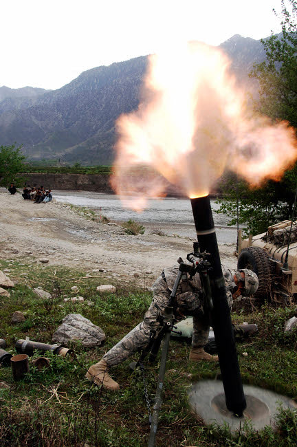 US Army soldier ducking from mortar blast in Afghanistan poster print.