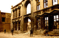 Soldiers patrolling a demolished building in Baghdad poster print.