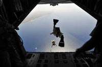 U.S. Air Force pararescueman jumping from HC-130P Hercules aircraft poster print.