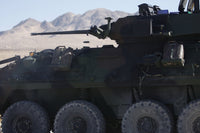 Light armored vehicle firing 25mm Bushmaster chain gun poster print