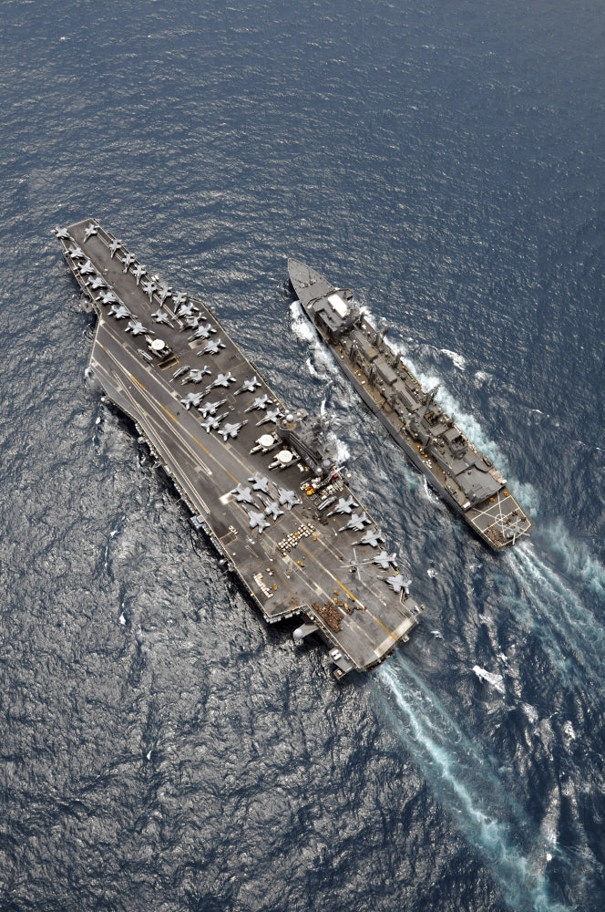Aerial view of USS Ronald Reagan and USNS Bridge during replenishment at sea poster print.