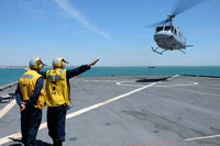 Airmen directing a Spanish navy AB-212 helicopter on USS Gunston Hall poster print.