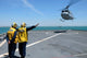 Airmen directing a Spanish navy AB-212 helicopter on USS Gunston Hall poster print.
