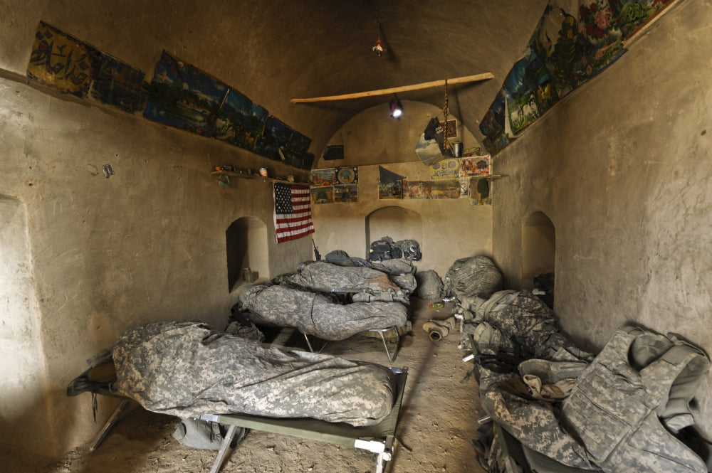 U.S. soldiers resting in an abandoned mud house during Operation Helmand Spider poster print.