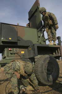 Marines preparing the antenna of an AN/TPQ-46A radar system poster print.