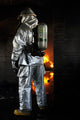Firefighter waiting to extinguish flames poster print by Stocktrek Images.