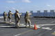Military policemen training with Beretta M9 9mm pistol aboard USS San Antonio poster print.