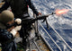 US Navy Airman firing M-240B machine gun aboard USS Essex poster print