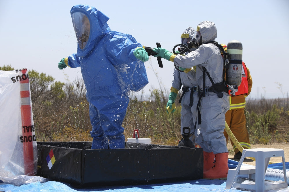Decontamination Process Poster Print featuring an airman in a tub of cleaning solution.
