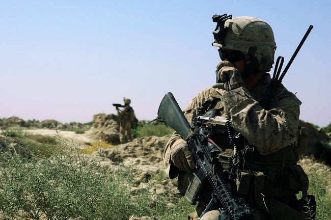 US Marine using a radio during a security patrol in Afghanistan poster print