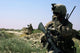 US Marine using a radio during a security patrol in Afghanistan poster print