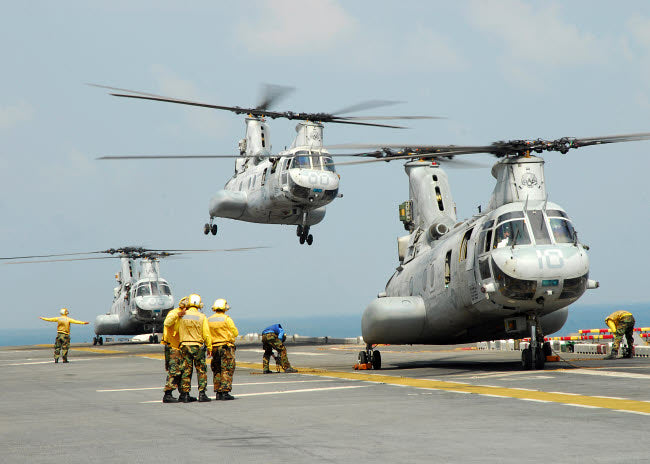 CH-46E Sea Knight helicopter taking off from USS Essex flight deck poster print.