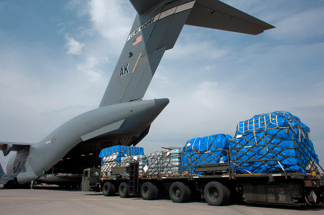 Japanese soldier marshaling vehicles from a C-17 Globemaster III poster print.