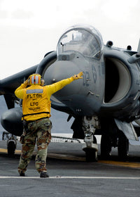 Aviation Boatswain's Mate directing pilot of AV-8B Harrier II Poster Print