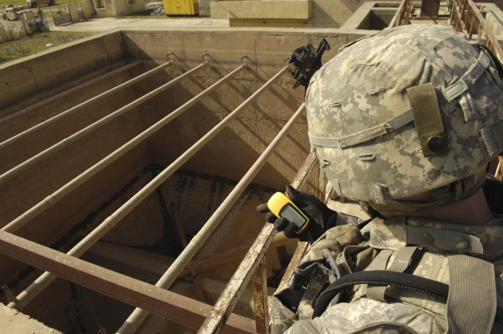 U.S. Army soldier taking GPS reading at water treatment plant in Iraq poster print.